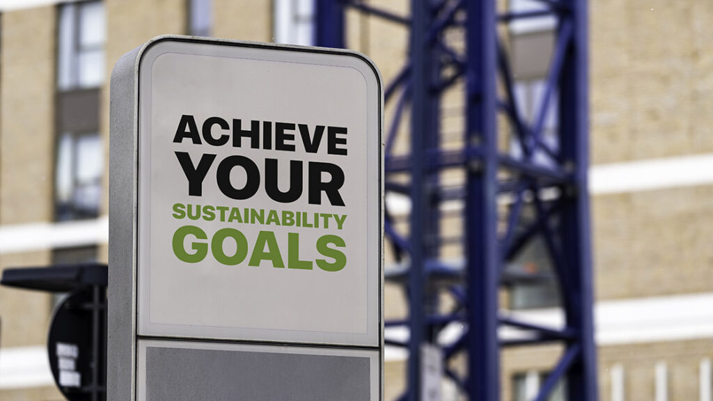 Sign says Achieve Your Sustainability Goals against a building