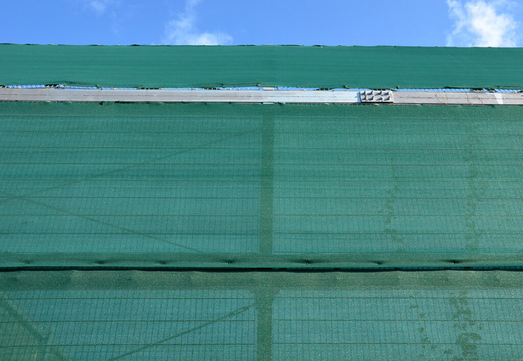 Screen placed around construction site to reduce noise and dust