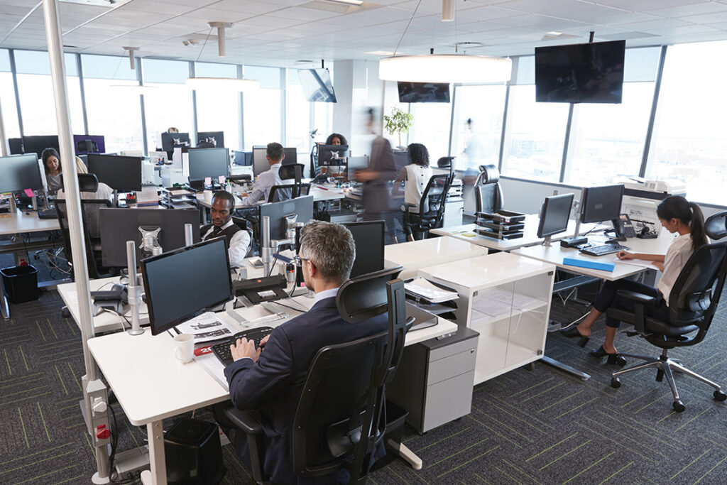 Office interior image. Shows people working in an open plan space.