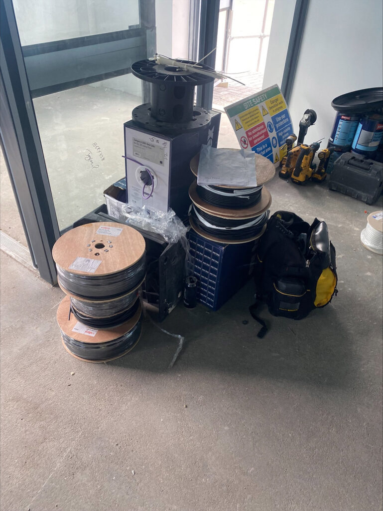 Reels of electrical cable neatly stacked by the door, ready for installation