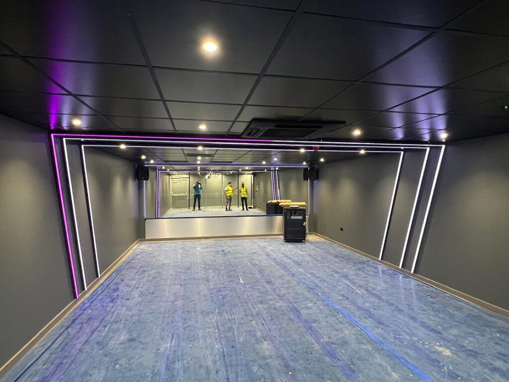 Exercise space with funky lighting and mirrored wall