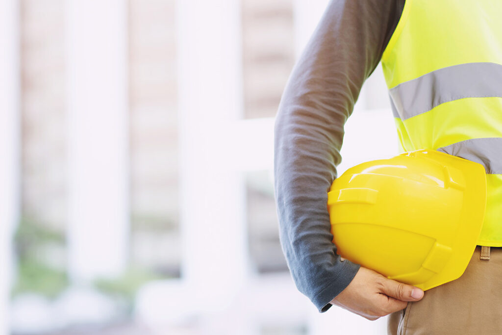 Builder with hard hat tucked under his arm